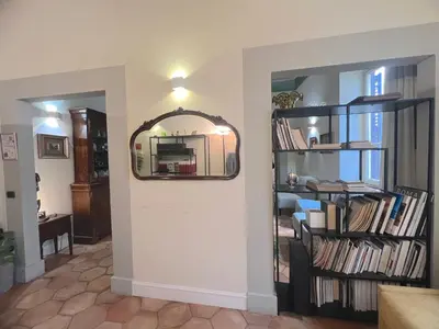 a living room with a fireplace and a table and chairs at Trevi Luxury in Rome