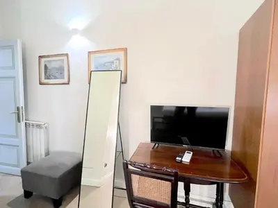 a living room with two chairs and a flat screen tv at Trevi Luxury in Rome