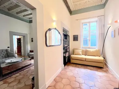 a living room with a couch and a tv at Trevi Luxury in Rome