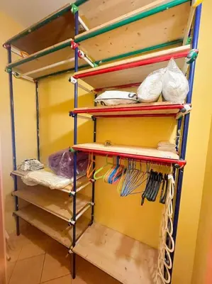 a room with a shelf with different items on it at the sun in rome in Rome