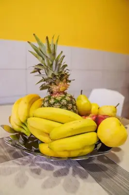 a bowl of bananas and other fruits on a table at the sun in rome in Rome