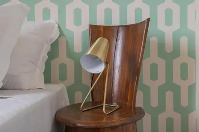 a lamp on a wooden end table next to a bed at Colosseum Loft - ZENO 12 in Rome