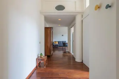 an open hallway with white walls and wood floors at Colosseum Loft - ZENO 12 in Rome