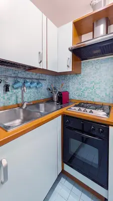 a kitchen with a sink and a stove at Colosseo 500 m Quiete in città A Casa di Beatrice in Rome