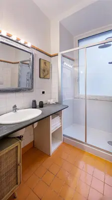 a bathroom with a tub and a sink and a shower at Colosseo 500 m Quiete in città A Casa di Beatrice in Rome