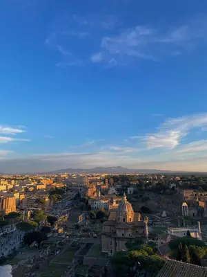 an aerial view of a city at sunset at Colosseo 500 m Quiete in città A Casa di Beatrice in Rome