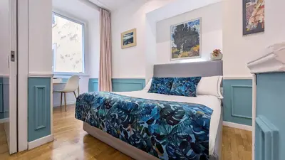 a bedroom with a bed and a table in it at Colosseo 500 m Quiete in città A Casa di Beatrice in Rome