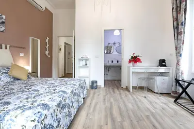 a small bedroom with a bed and a window at Molly Home in Rome