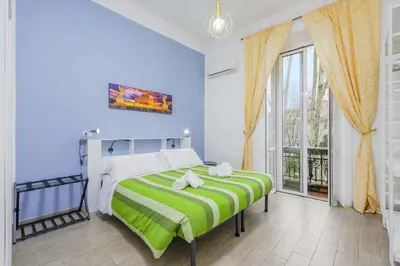 a bedroom with a bed and a large window at Molly Home in Rome