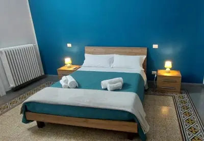 a bedroom with a bed with towels on it at Big House Colosseo in Rome
