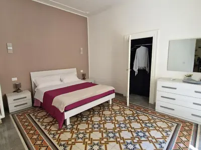 a bedroom with a bed and a dresser at Big House Colosseo in Rome
