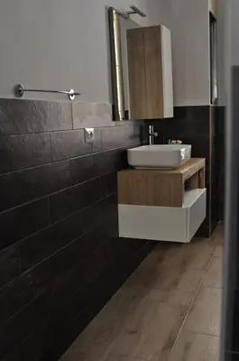 a bathroom with a sink and a mirror at Big House Colosseo in Rome