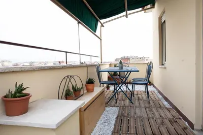 a balcony with a table and chairs on it at Belvedere pigneto in Rome