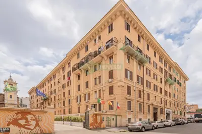 a large building with cars parked in front of it at Daniela, pied-à-terre al Vaticano in Rome