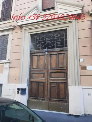 a large wooden door on the side of a building at Daniela, pied-à-terre al Vaticano in Rome