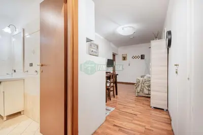 a room with a kitchen and a dining room at Daniela, pied-à-terre al Vaticano in Rome