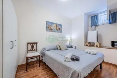 a bedroom with a bed and a chair in it at Daniela, pied-à-terre al Vaticano in Rome