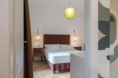 a hotel room with a bed and two night stands at Residenza Clodio Vatican in Rome