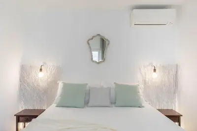 a bedroom with a large white bed with two tables at iFlat Penthouse in Campo de' Fiori in Rome