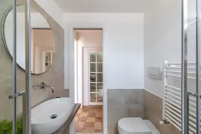 a bathroom with a sink and a toilet and a mirror at iFlat Penthouse in Campo de' Fiori in Rome