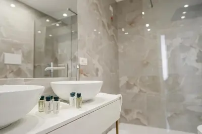 a bathroom with two sinks and a mirror at Màs Boutique Hotel Rome in Rome