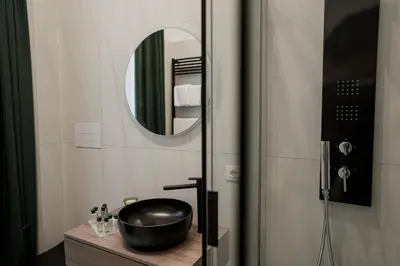 a bathroom with a sink and a mirror at Màs Boutique Hotel Rome in Rome