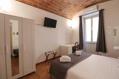 a bedroom with a bed and a window at Casa Cecilia a Monti in Rome