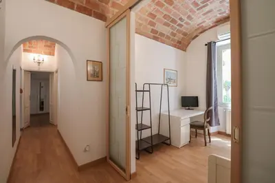 a hallway with an archway and a desk in a room at Casa Cecilia a Monti in Rome