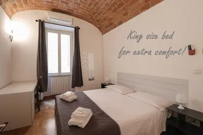 a bedroom with a bed and a brick wall at Casa Cecilia a Monti in Rome