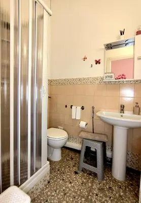 a bathroom with a toilet and a sink at Bed and Breakfast Mamma Giuliana in Rome