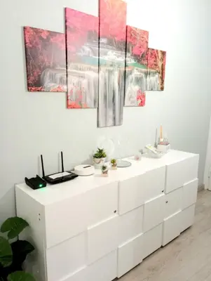 a white dresser in a room with paintings on the wall at Bed and Breakfast Mamma Giuliana in Rome