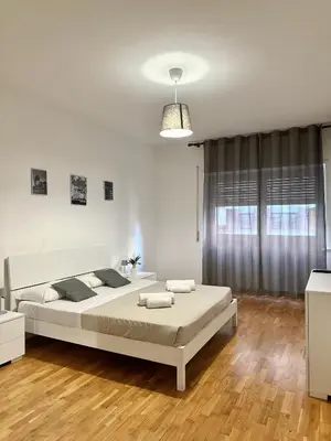 a bedroom with a large bed in a room at Maison DaLù in Rome