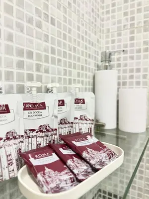 a bathroom counter with toothbrushes and other products on it at Maison DaLù in Rome