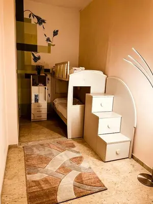 a small bedroom with a bunk bed and a rug at Sina Rent Room in Rome