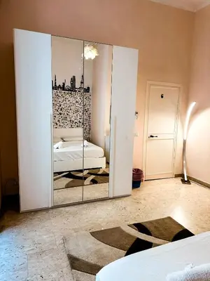 a large mirror in a room with a bed at Sina Rent Room in Rome