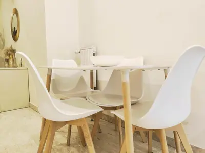a white dining room table with white chairs at The italian House in Rome a pochi passi dalla metro A in Rome
