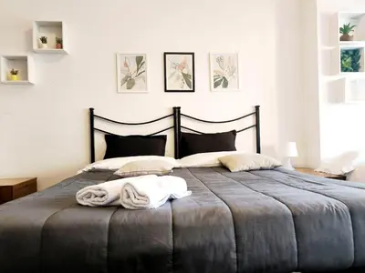 a bedroom with a large bed with towels on it at The italian House in Rome a pochi passi dalla metro A in Rome