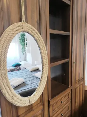 a mirror hanging in a room with a bed at The italian House in Rome a pochi passi dalla metro A in Rome