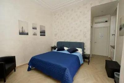 a bedroom with a blue bed in a room at Rohome Stay in Rome