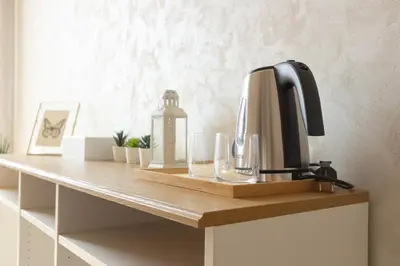 a coffee maker and glasses on a table at Rohome Stay in Rome