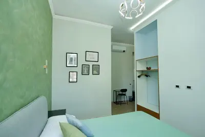 a bedroom with a bed and a mirror at Rohome Stay in Rome