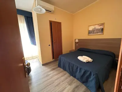 a bedroom with a bed with a towel on it at Accommodation Corallo in Rome