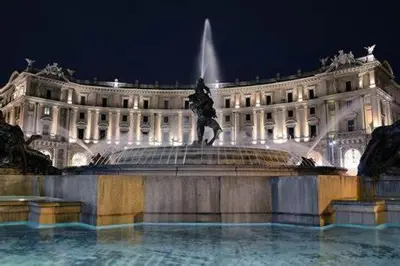 a large building with a fountain in front of it at Accommodation Corallo in Rome