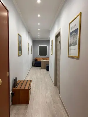 a small room with two beds and a mirror at Accommodation Corallo in Rome