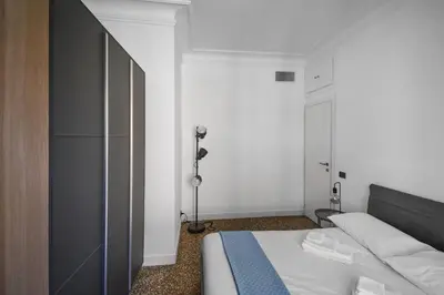 a small bedroom with a bed and a lamp at Aurelia's Hideaway, Near Vatican in Rome