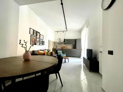 a living room with a table and a kitchen at Aurelia's Hideaway, Near Vatican in Rome