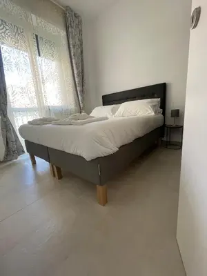 a bed in a room with a large window at Aurelia's Hideaway, Near Vatican in Rome