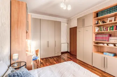 a bedroom with white cabinets and a bed at Vacanze romane in Rome