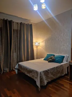 a bedroom with a bed with a light on it at Vacanze romane in Rome