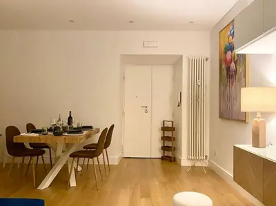 a dining room with a table and chairs in a kitchen at Maison de charme Domus Clodio XIV in Rome